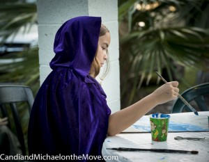 A young girl adding her magic to the giant mural