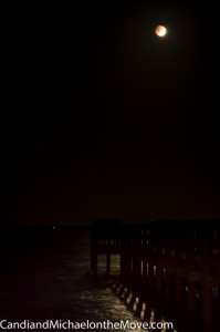 The moon lighting up the water at the very start of the eclipse
