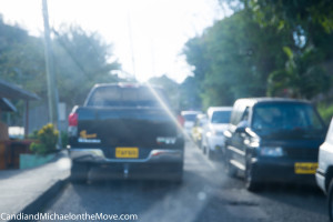 Here is a typical view on the major road around the island.  In the US, this would be equivalent to a parkway.  The left lane is entirely blocked by a parked truck so you wait for the cars to stop coming in the other direction and then race around the parked car before more cars come.  It's often a game of chicken.  Do NOT play against busses, taxis or trucks - they always win.