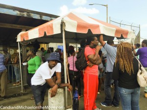 A portion of the line of people waiting to get into the port to retrieve barrels or containers.