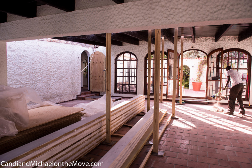 Lots to see in this picture - temporary door so we can lock it at night (since living room is no longer secure), the platform that was built to cover the low spot in the floor (that collects water), clean up every day (so the house is livable during construction).