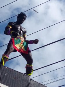 Masquerader dancing on top of speakers